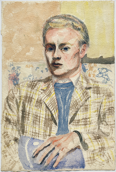 Lawrence Alloway, a man with blonde hair, sits with his arms crossed on a print couch, wearing a yellow and brown plaid jacket, and blue sweater with a white collar peeking out. The wall behind him shows two panels of beige (left) and yellow (right.)