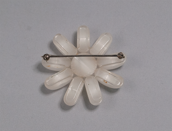 White flower-shaped brooch