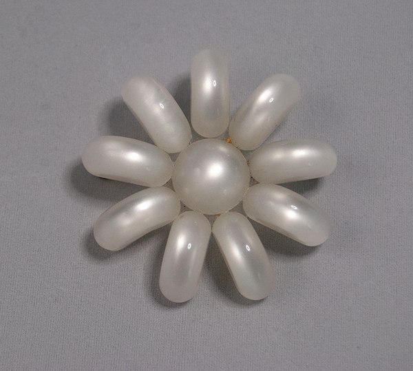 White flower-shaped brooch