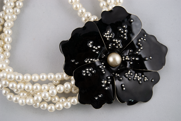 Pearl necklace with black flower (closeup)