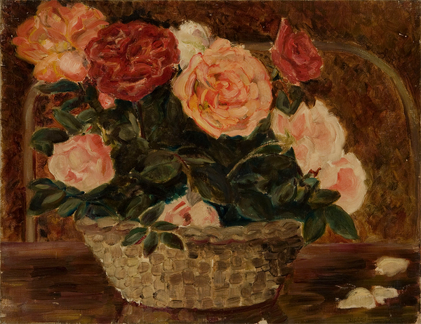 A basket of pink and red roses on a brown table.
