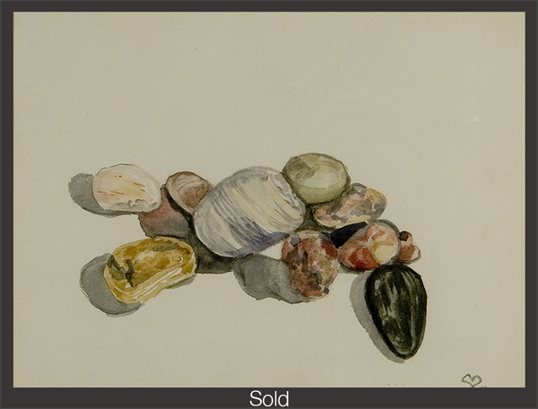 A group of small and large stones on a black surface. The stones range from solid to patterned, in white, yellow, pinks, and grey tones. One egg-shaped black stone stands out from the others, to the bottom right hand side, with the pointed part facing the viewer. The piece is marked as sold with a grey border and white text "Sold" at the bottom center.